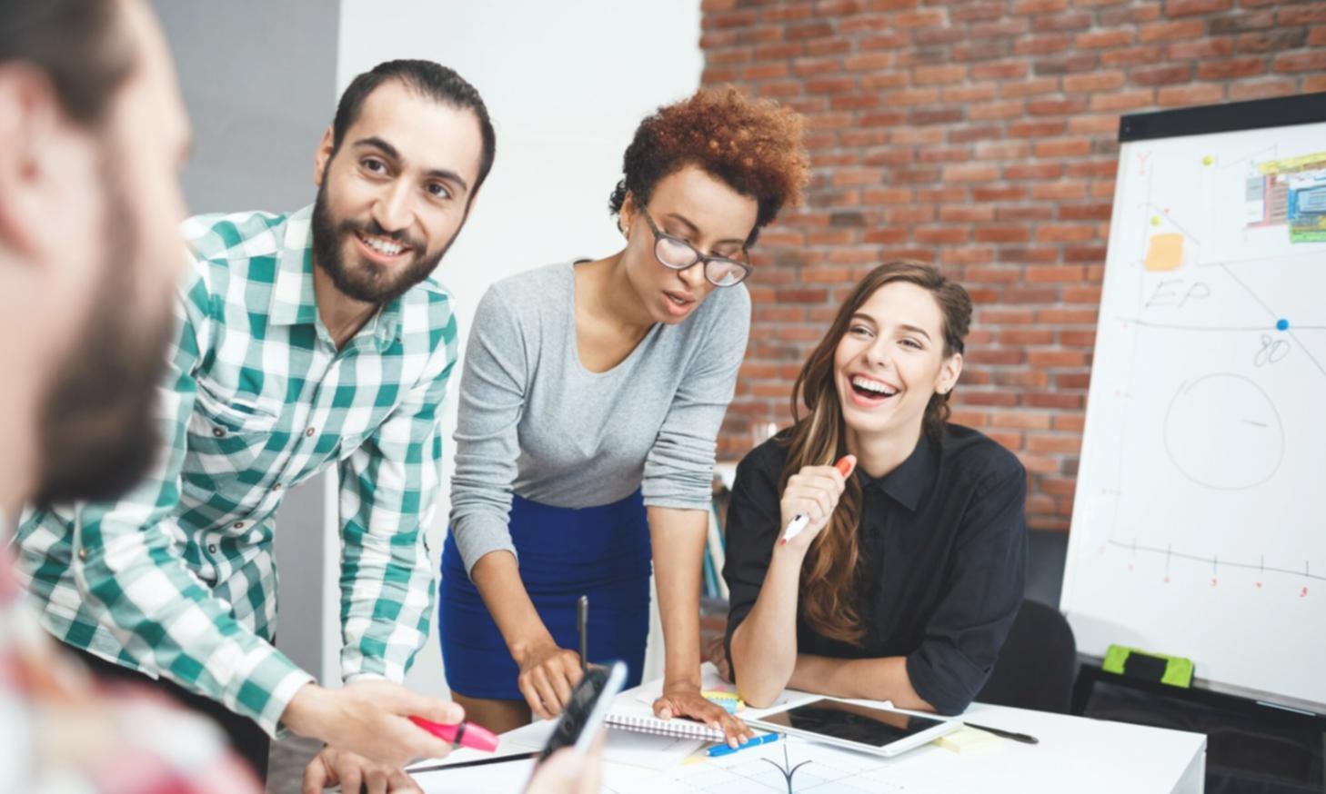 Strategic business planning session with documents and charts spread across conference table